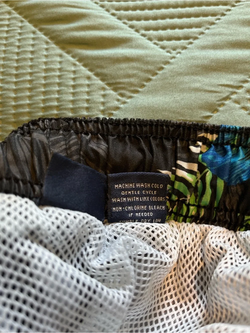 Pair of Kanu Surf Men's Blue Camo & Black Floral Swim Trunks
